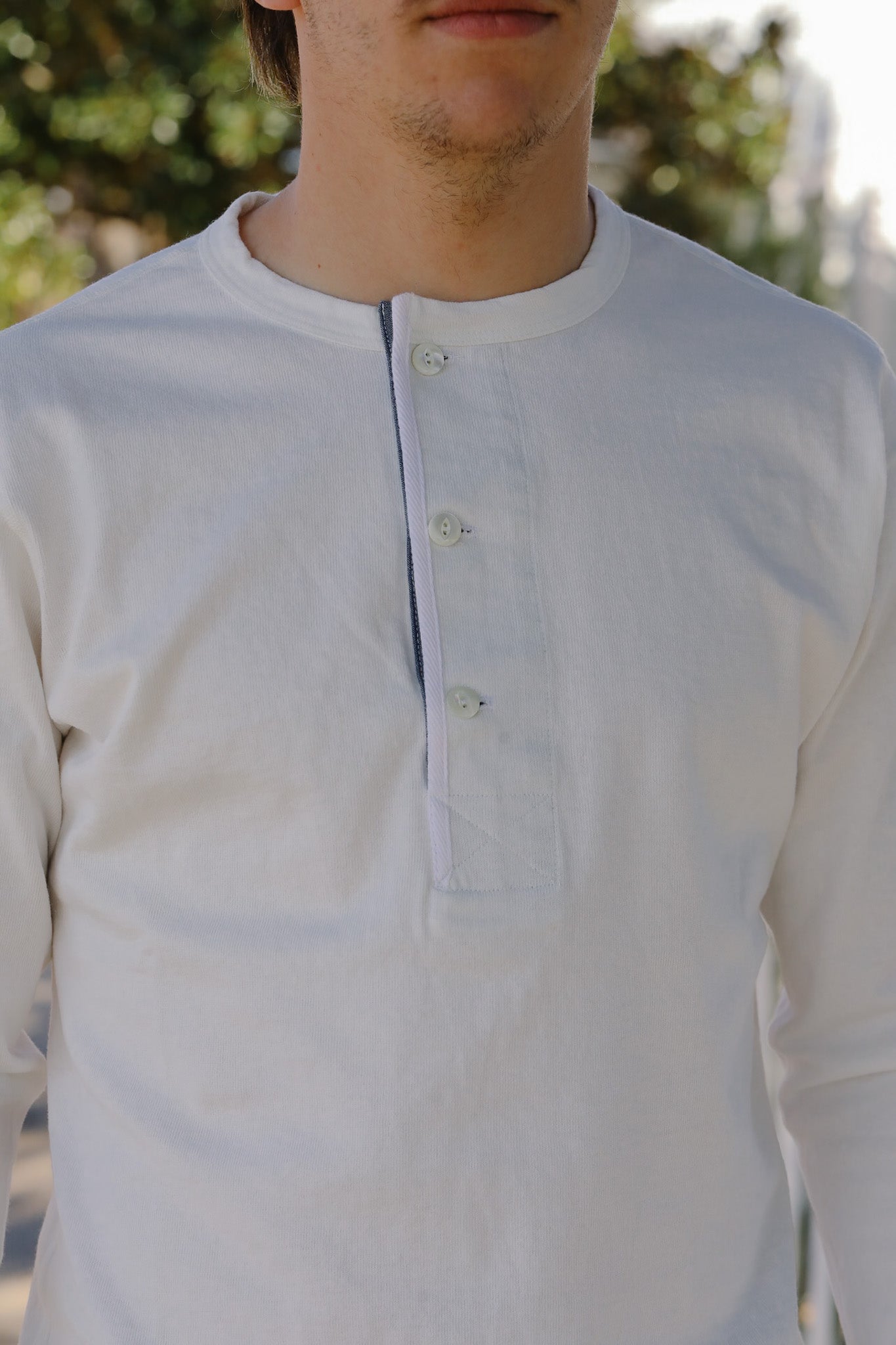 Light blue long-sleeve shirt worn by a person with a blurred background
