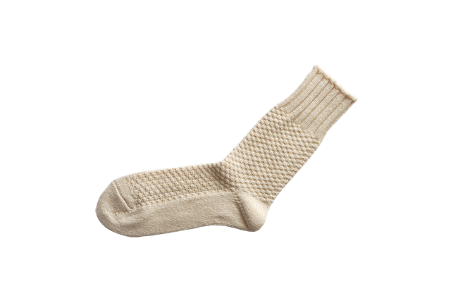 Beige knitted wool sock with textured pattern and ribbed cuff from Iron Shop Provisions
