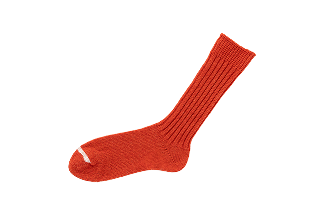 Single orange ribbed knit crew sock with white toe detail isolated on white