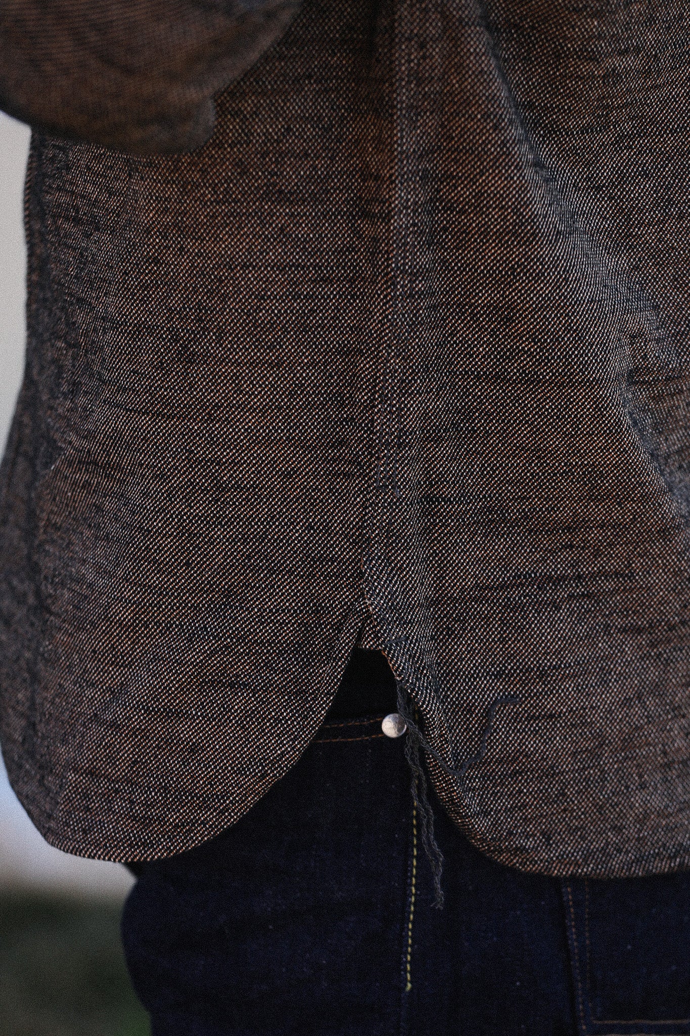 Close-up of a textured brown jacket with a blurred background