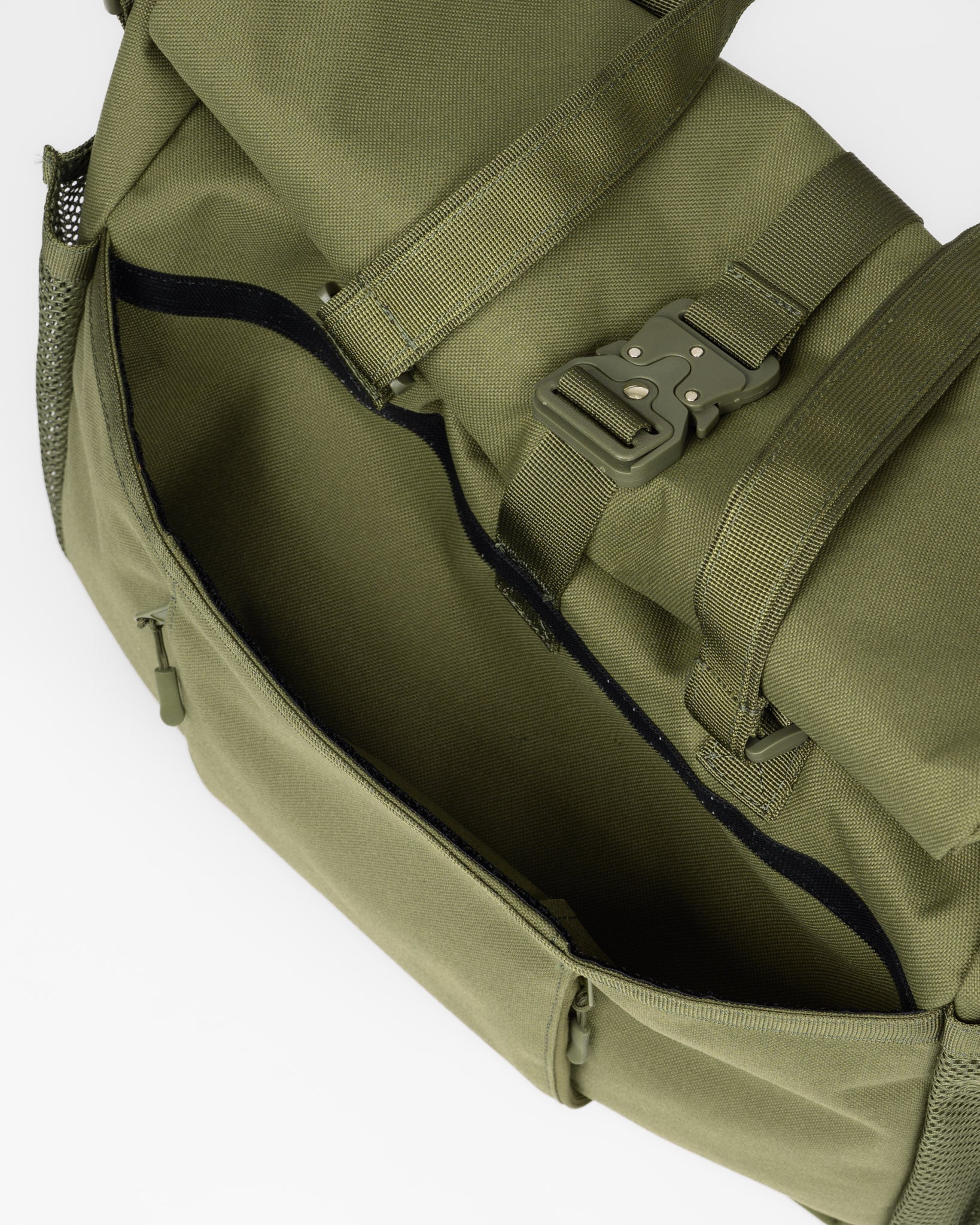 Close-up of an olive green canvas bag with a roll-top closure, adjustable webbing strap, and plastic buckle, shown against a plain white background.