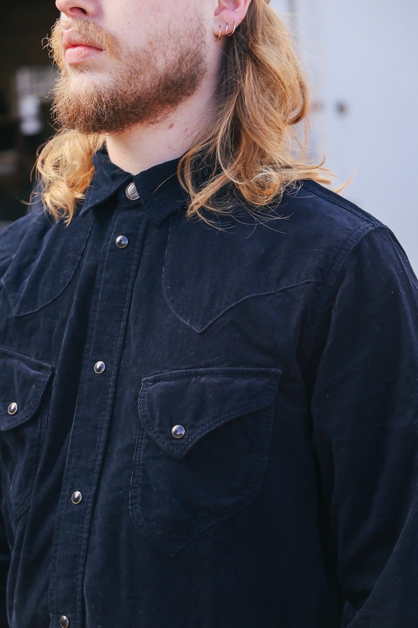 man wearing black corduroy western shirt