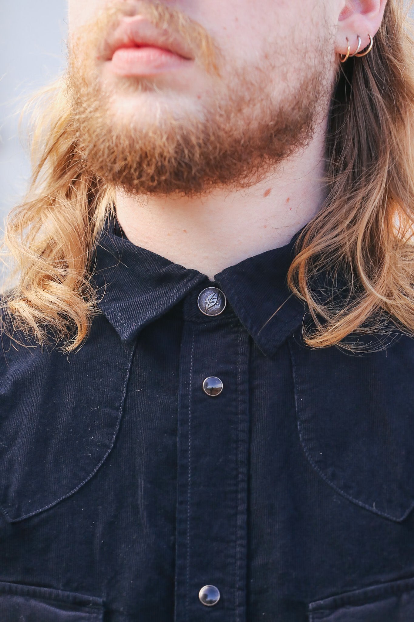 man wearing black corduroy western shirt