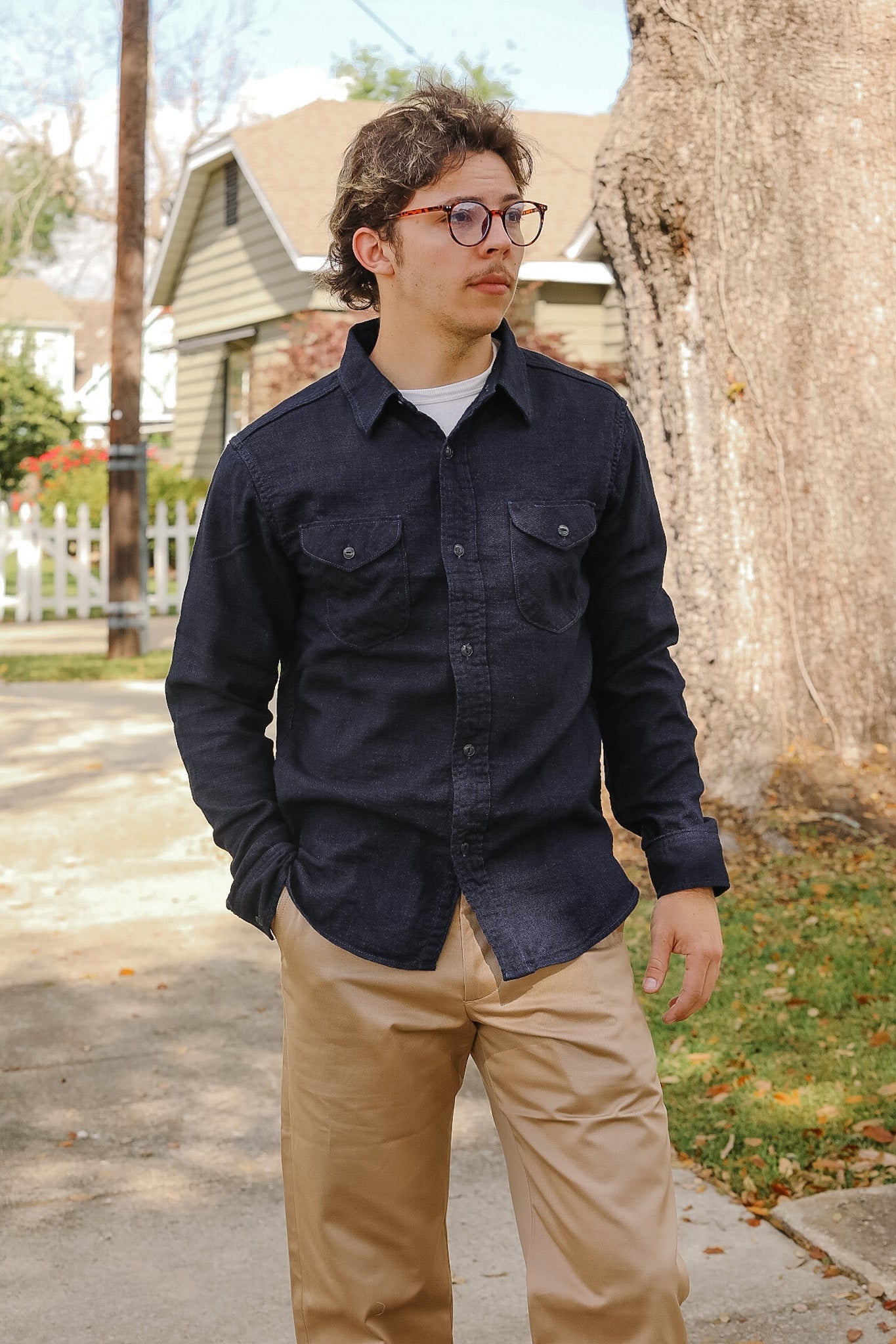 man wearing dark blue shirt on sidewalk