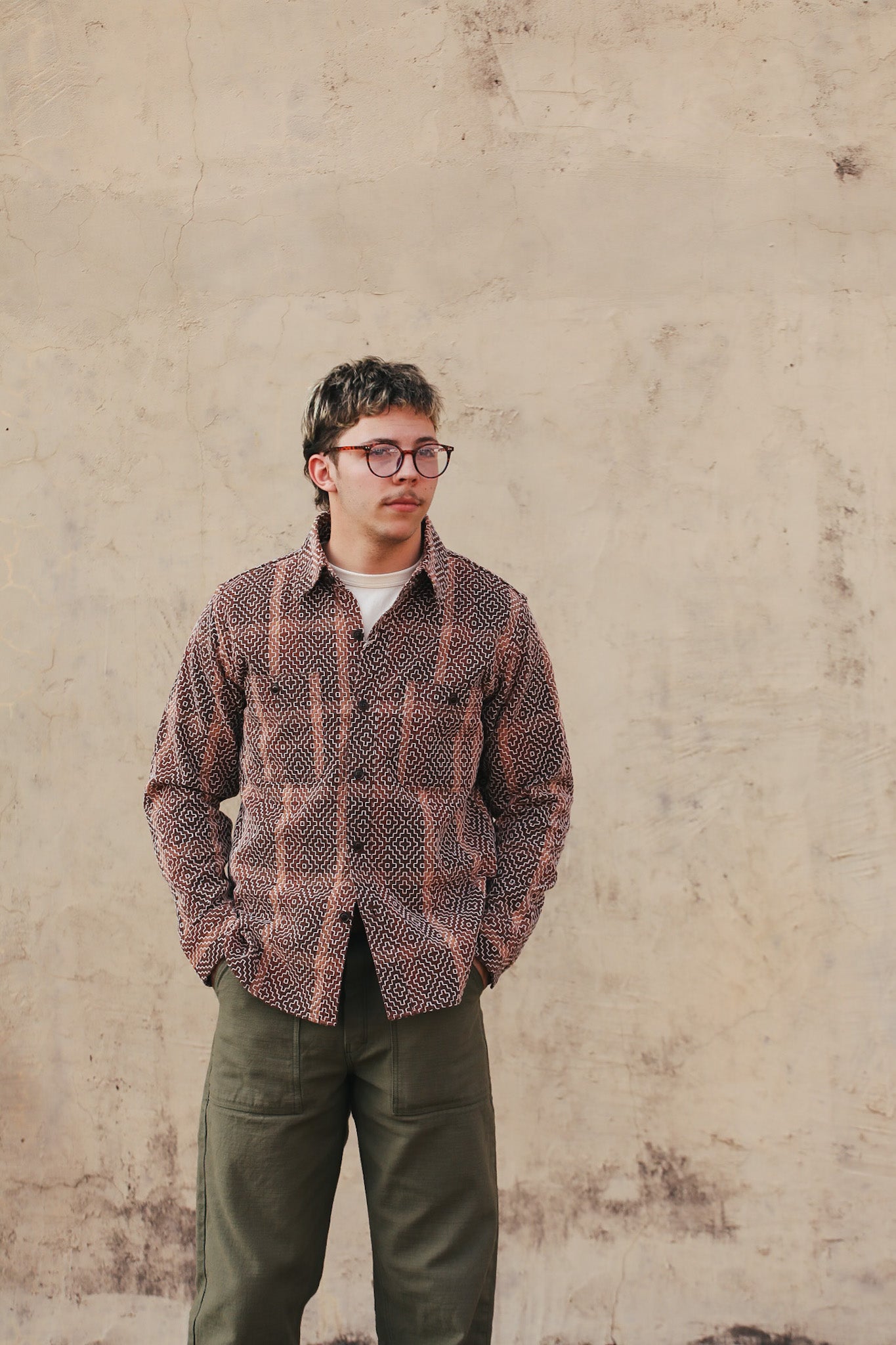 man wearing sashiko shirt on beige background