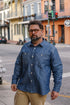 Man wearing a blue denim shirt on a city street