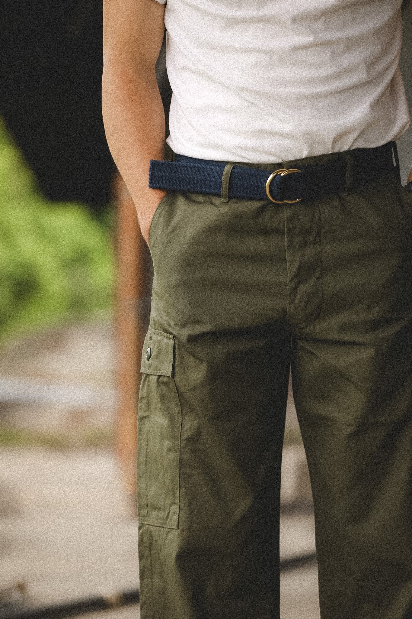 Person wearing green cargo pants with a blurred background