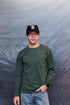 man wearing green long sleeve t-shirt