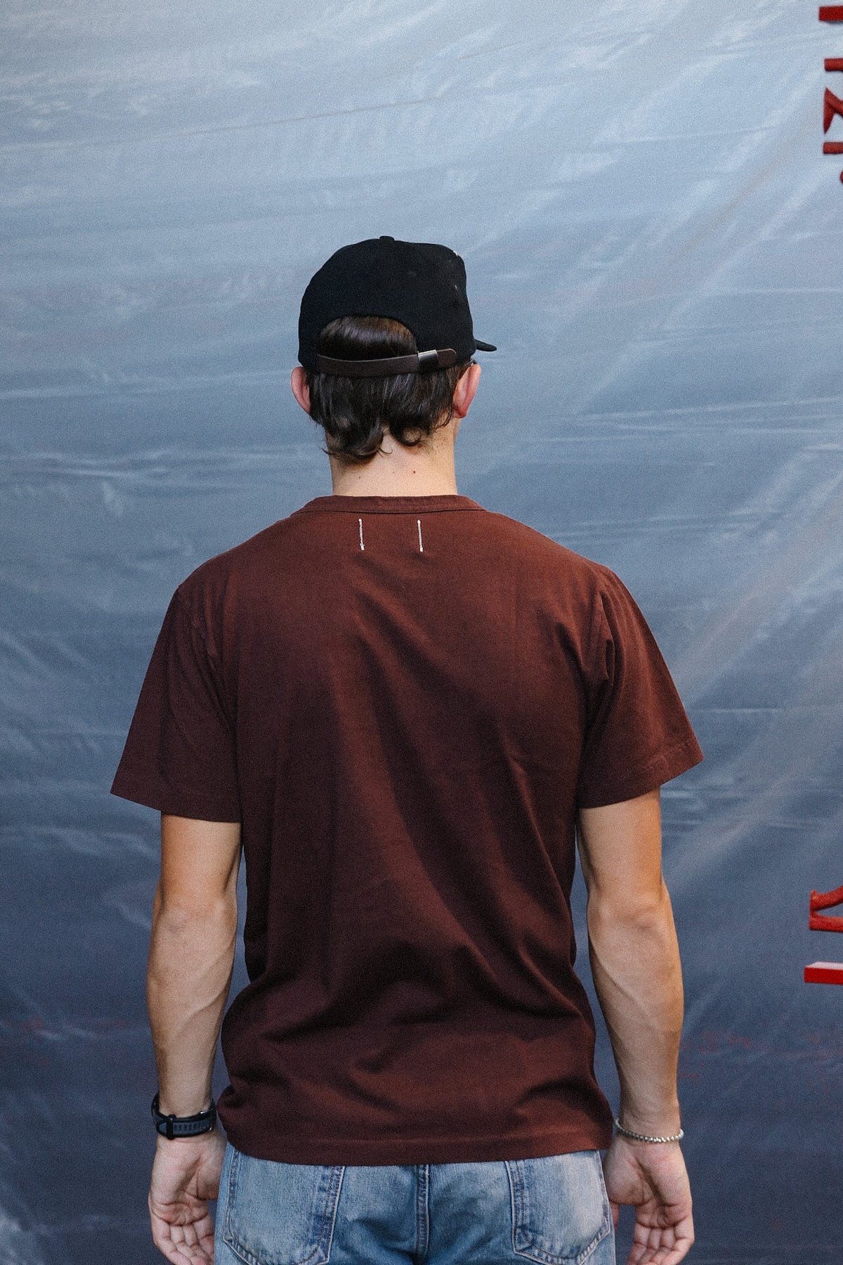 man wearing a burgundy t-shirt with a pocket