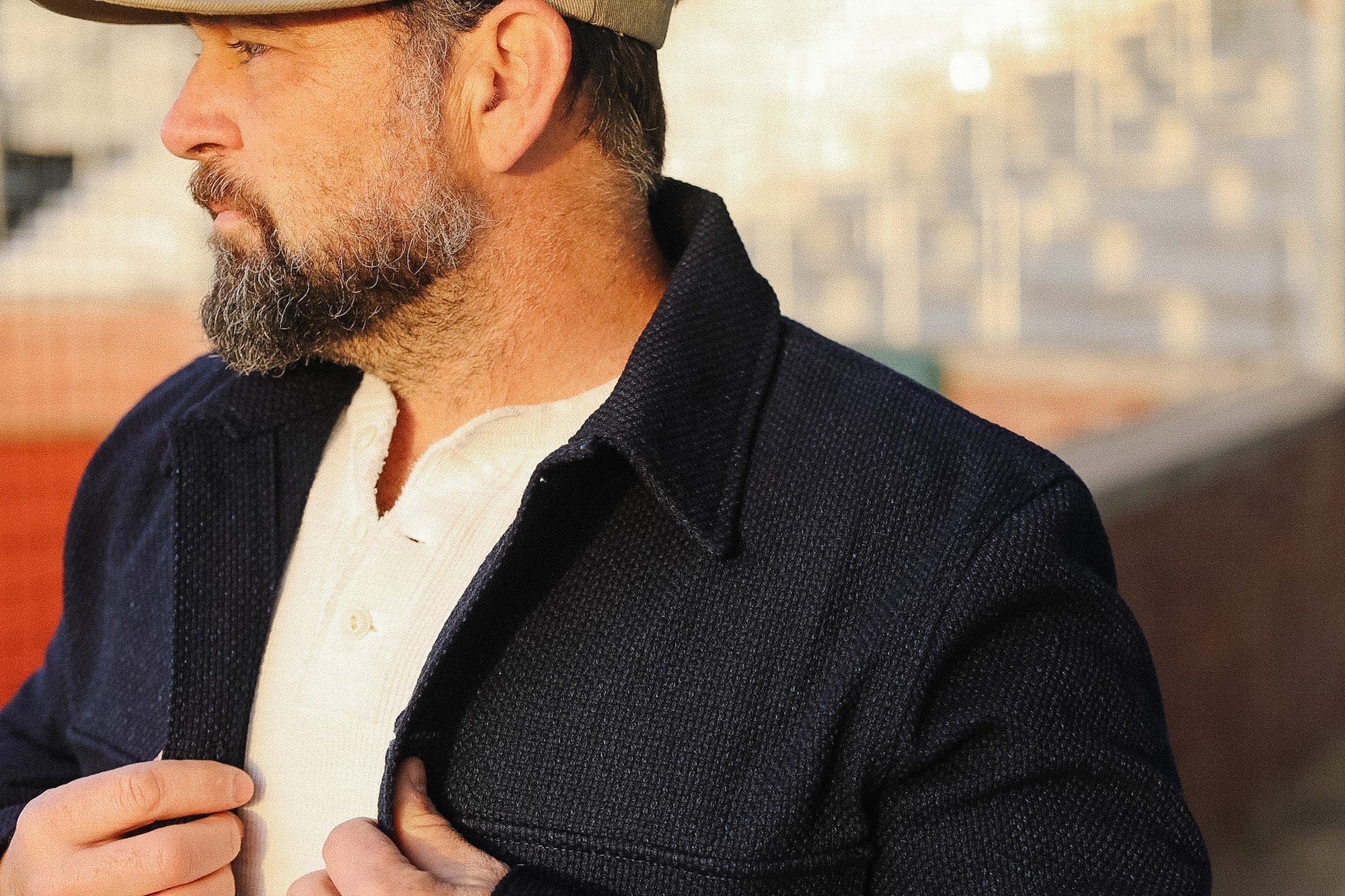 Man wearing a dark coat with a blurred background