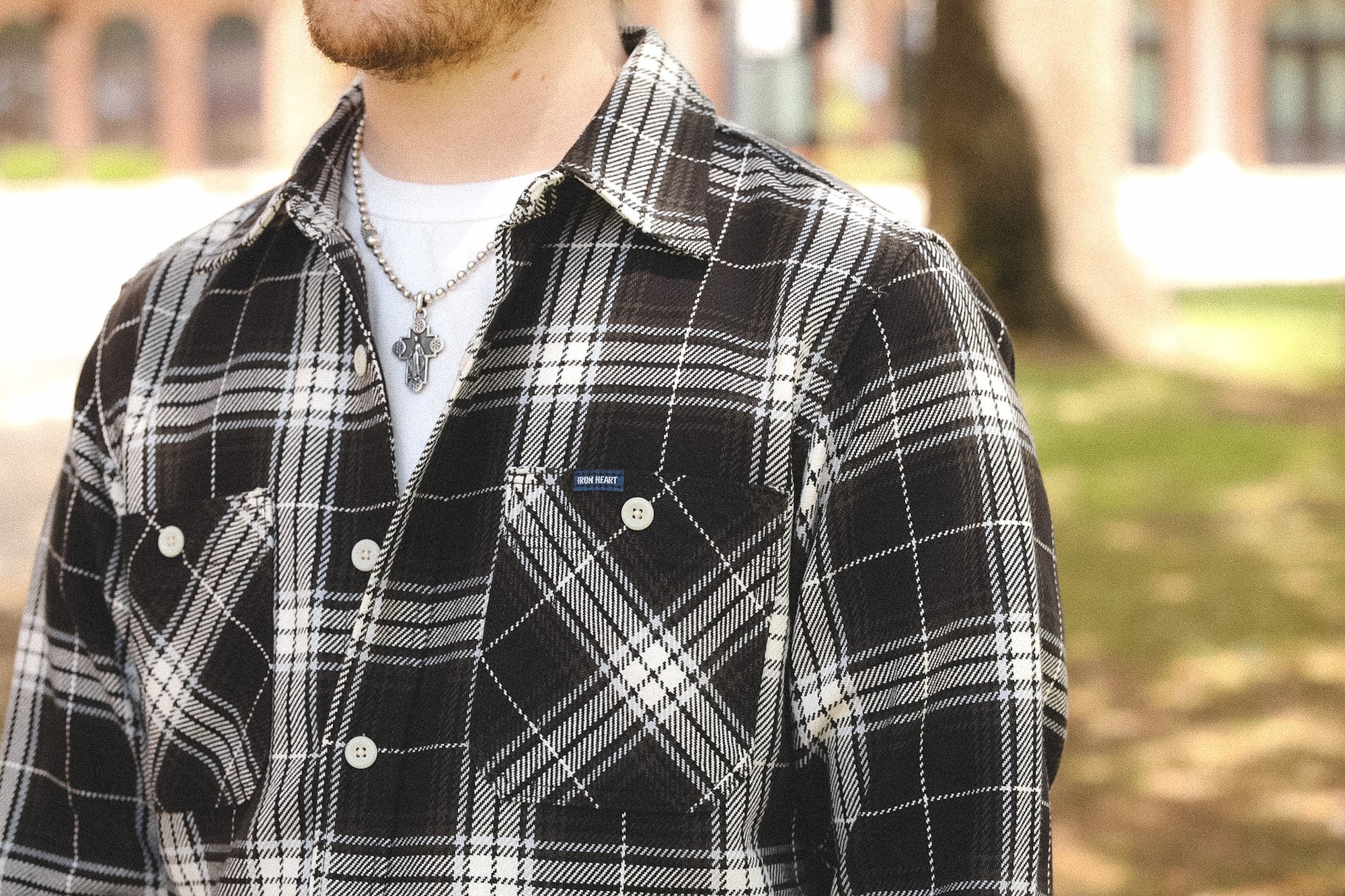 detail of plaid black shirt outdoors on a blurred background 