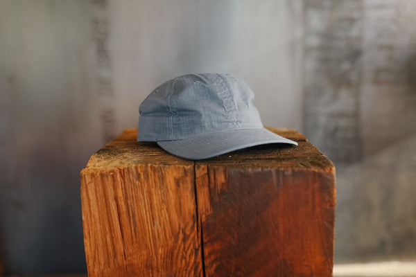 Blue cap on a wooden block with a blurred background
