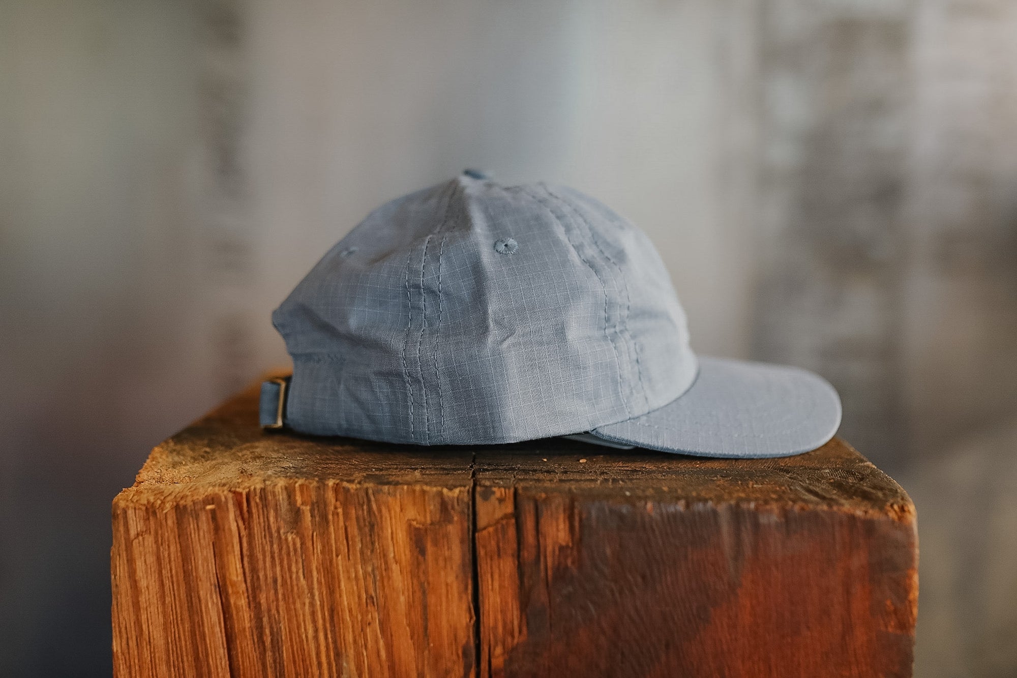 Gray cap on a wooden block with a blurred background