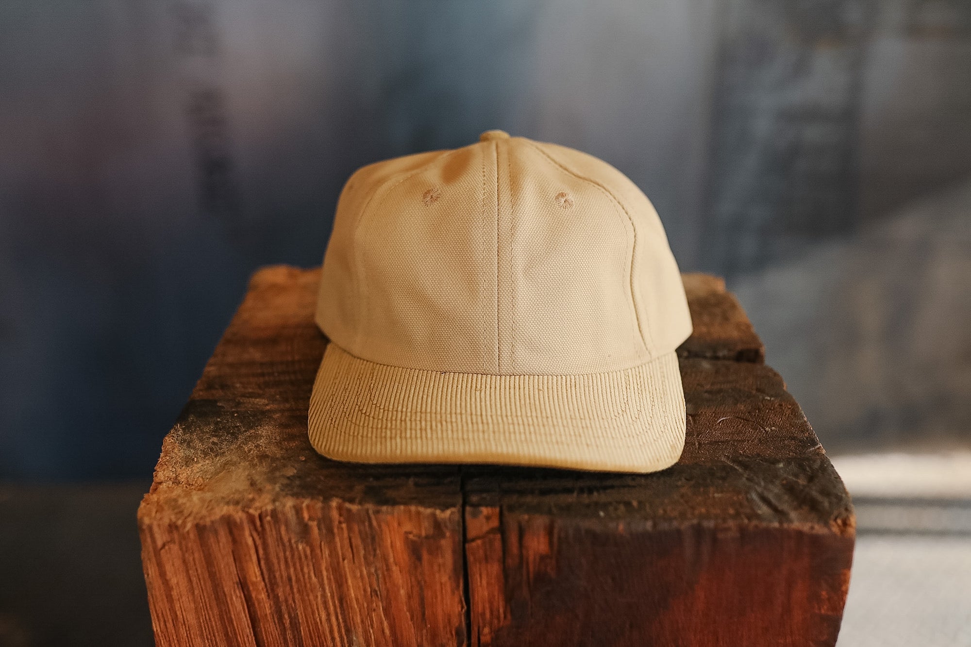Beige cap on a wooden block with a blurred background