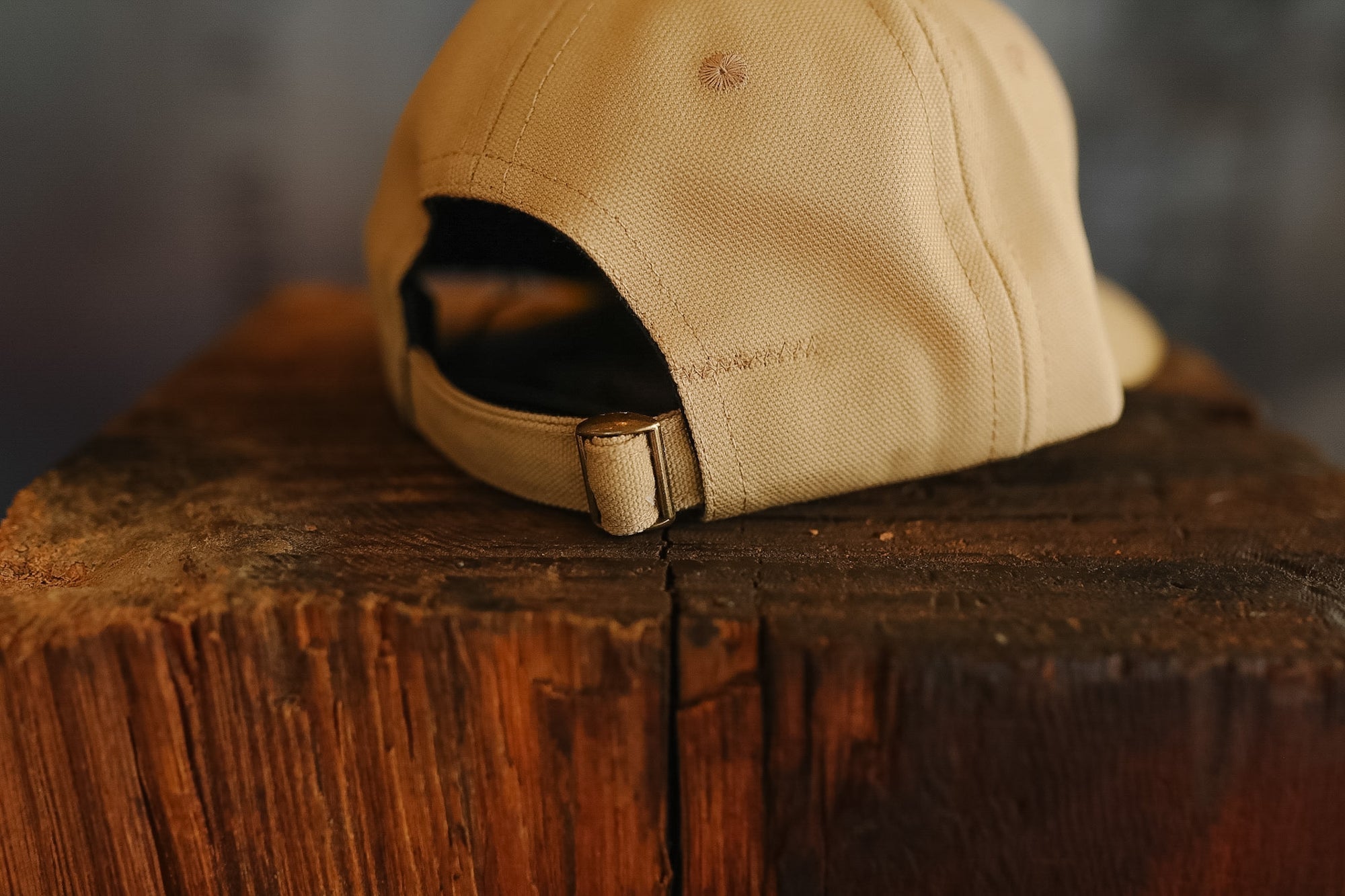 Beige cap on a wooden surface with a blurred background