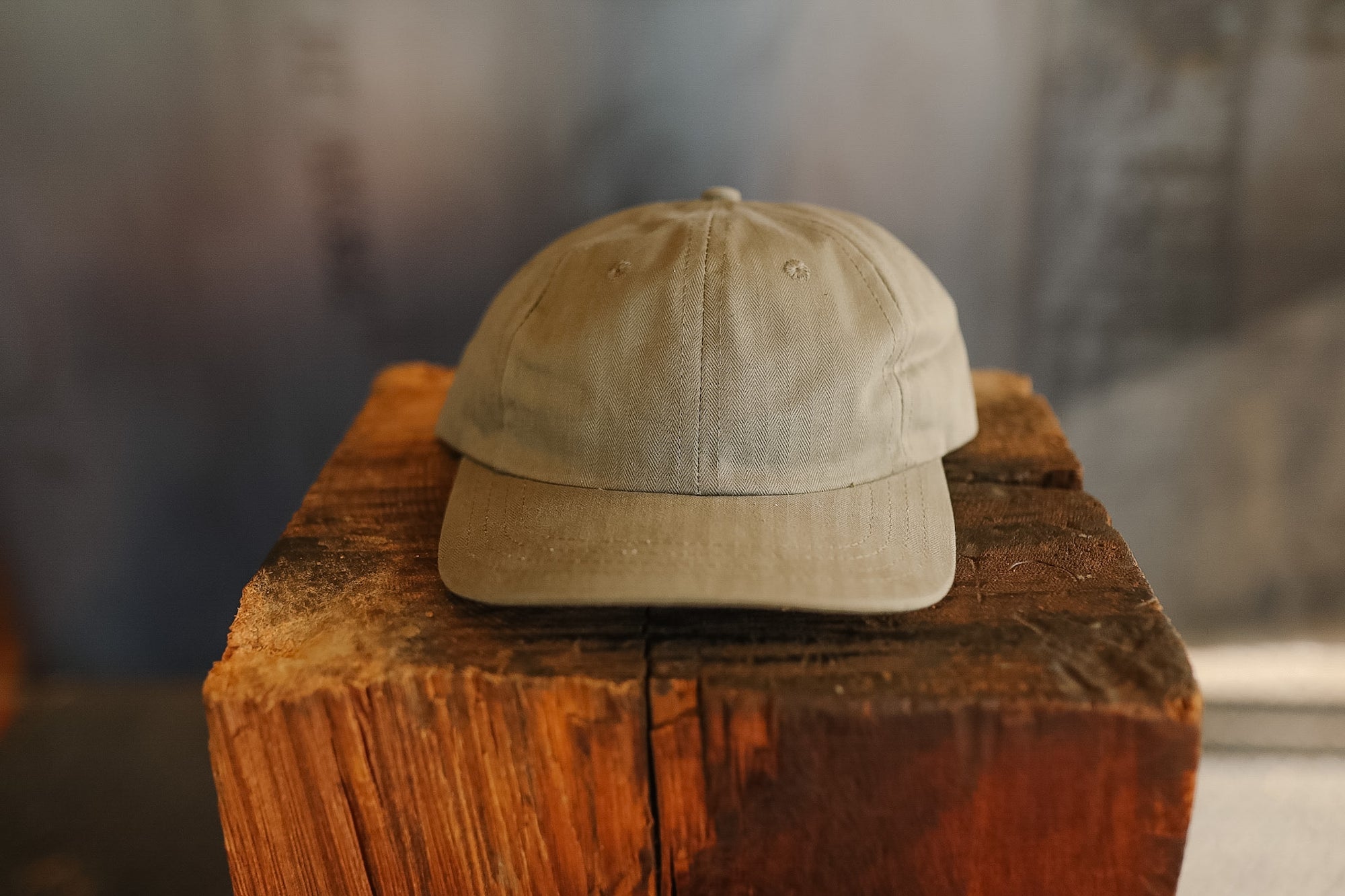 Beige cap on a wooden block with a blurred background