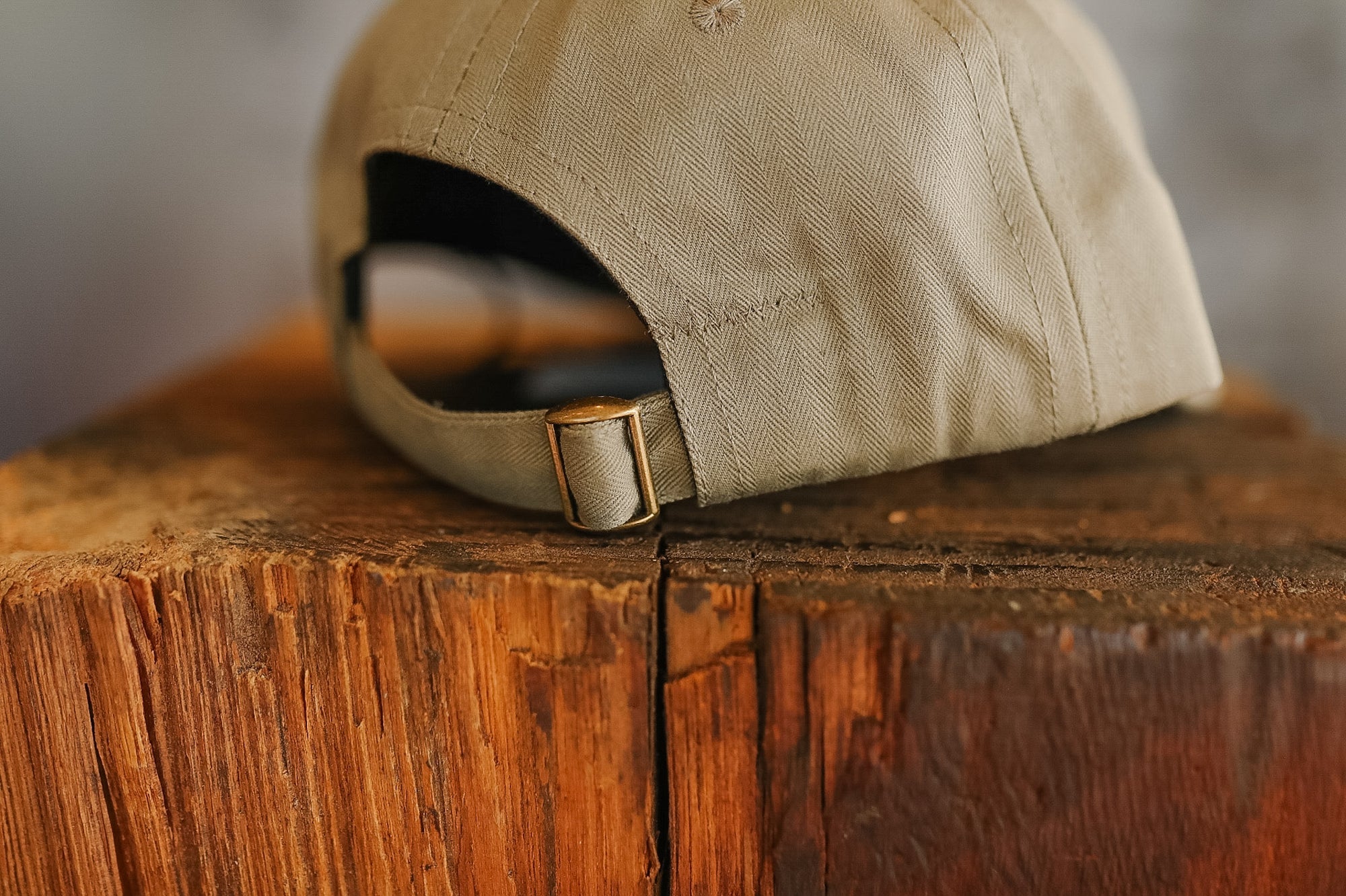 Beige cap on a wooden surface with a blurred background