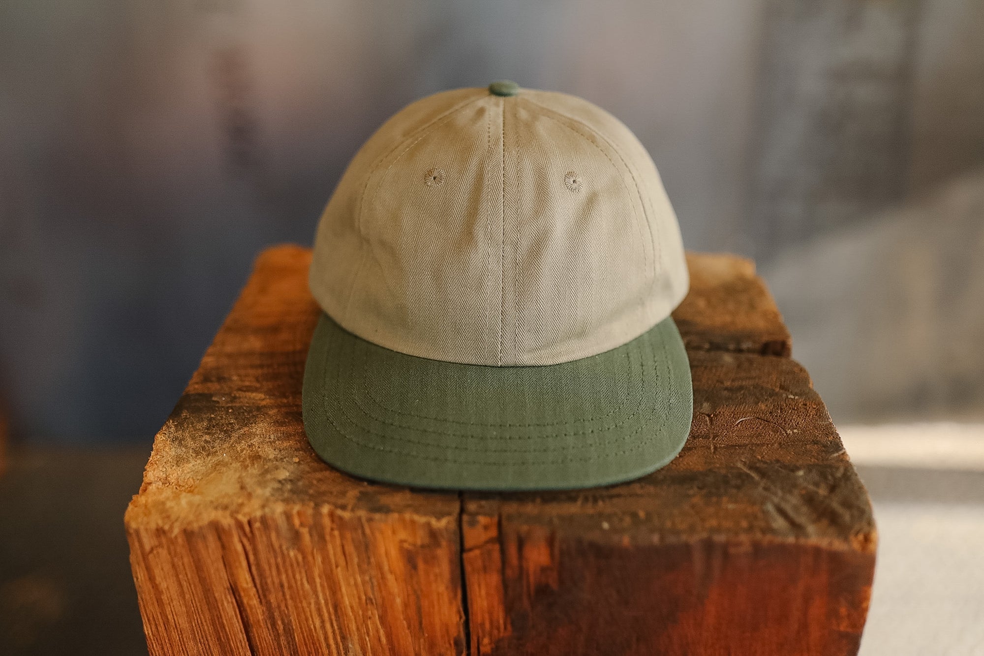 Two-tone cap on a wooden block with a blurred background
