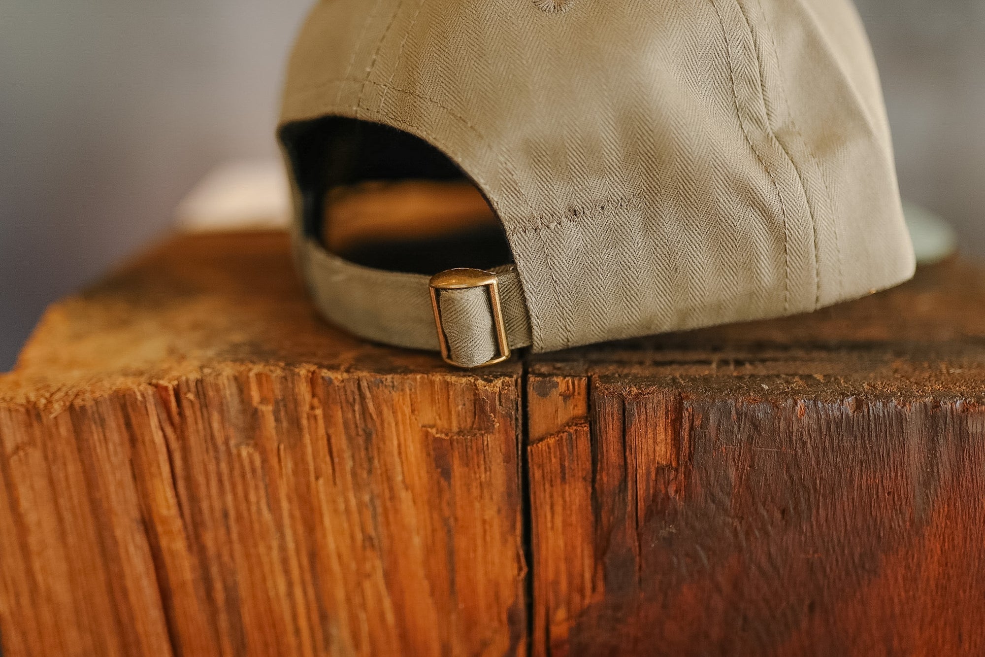 Beige cap on a wooden surface with a blurred background