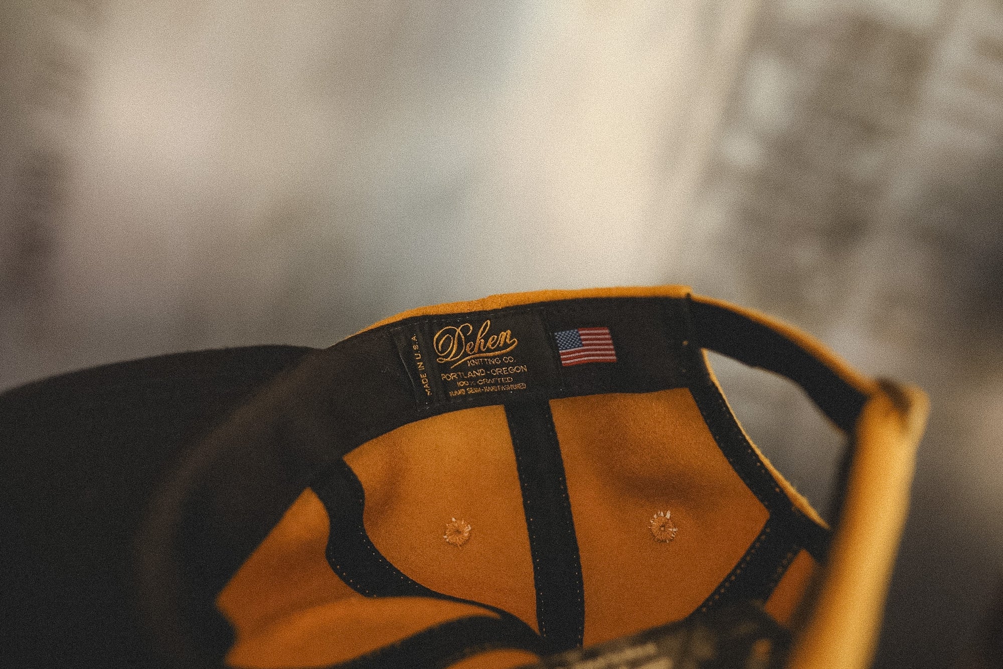 Close-up of a cap with a brand logo and American flag on a blurred background