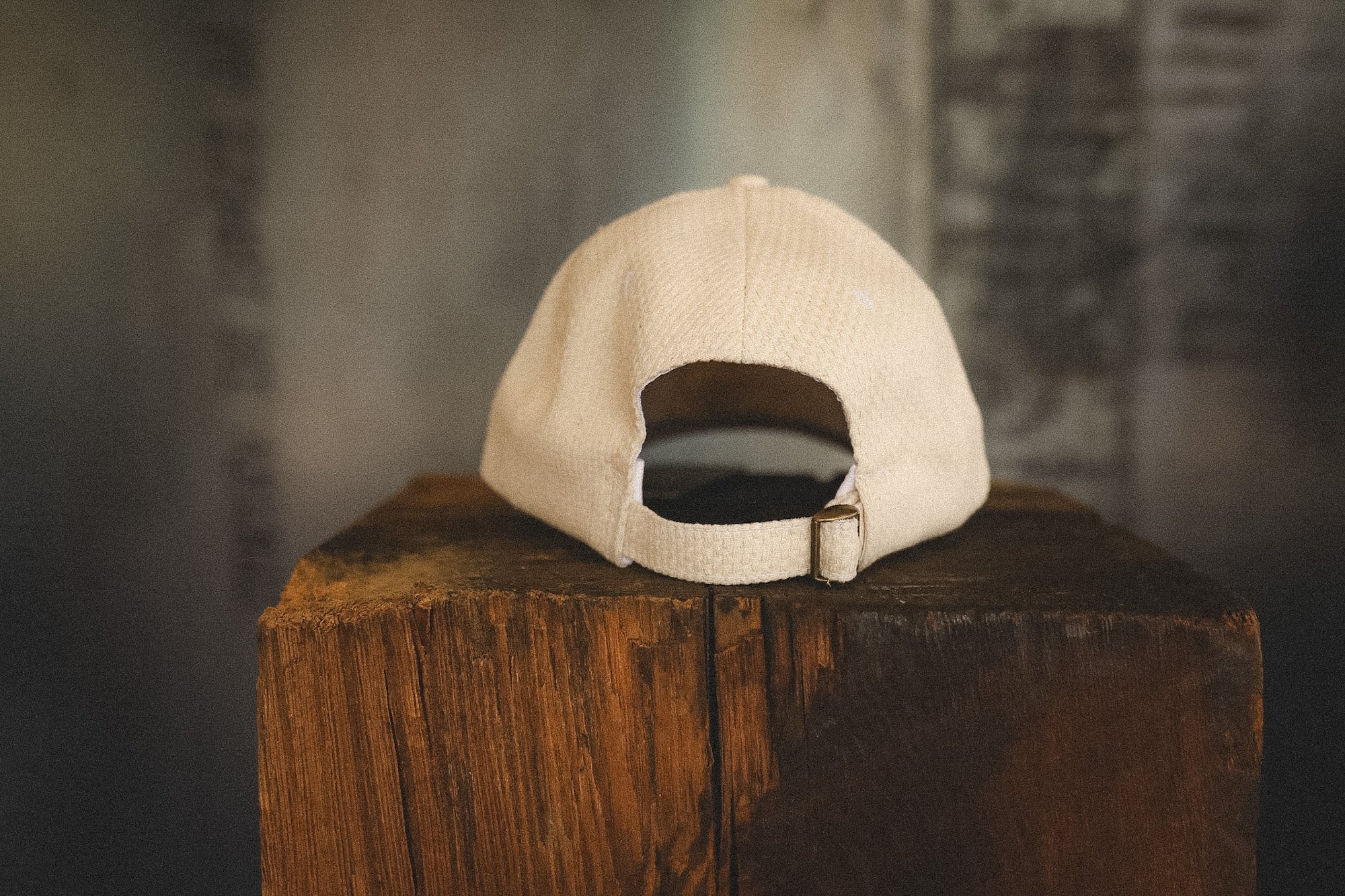 Beige cap on a wooden block with a blurred background