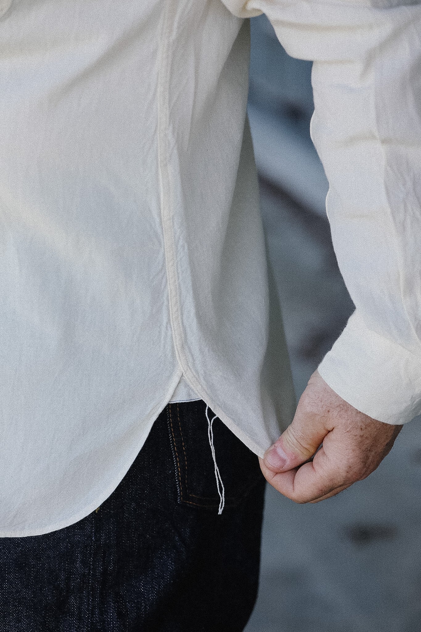 Close-up of a person wearing a white shirt with a blurred background