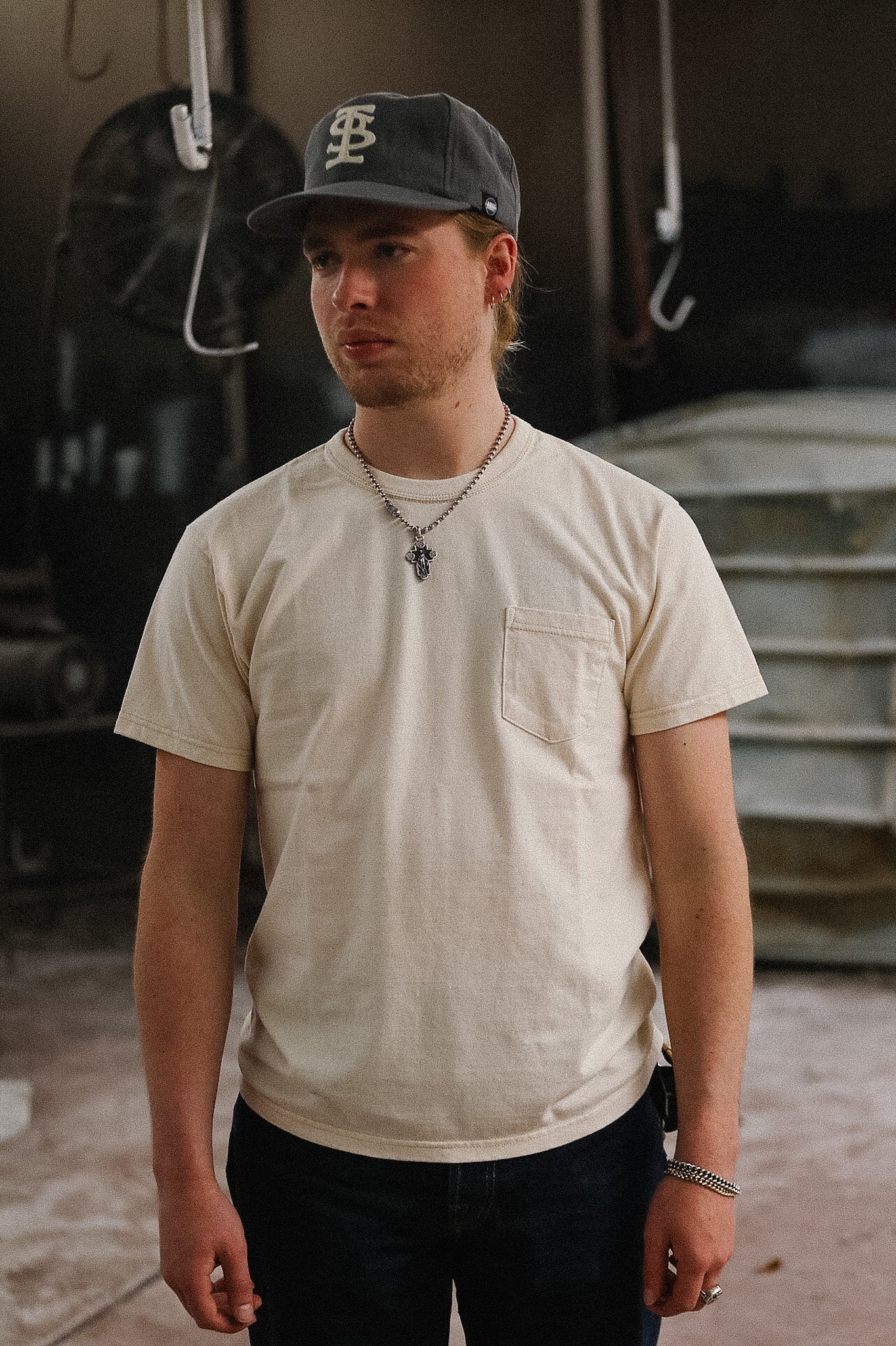 man wearing cream t-shirt on blurred background 