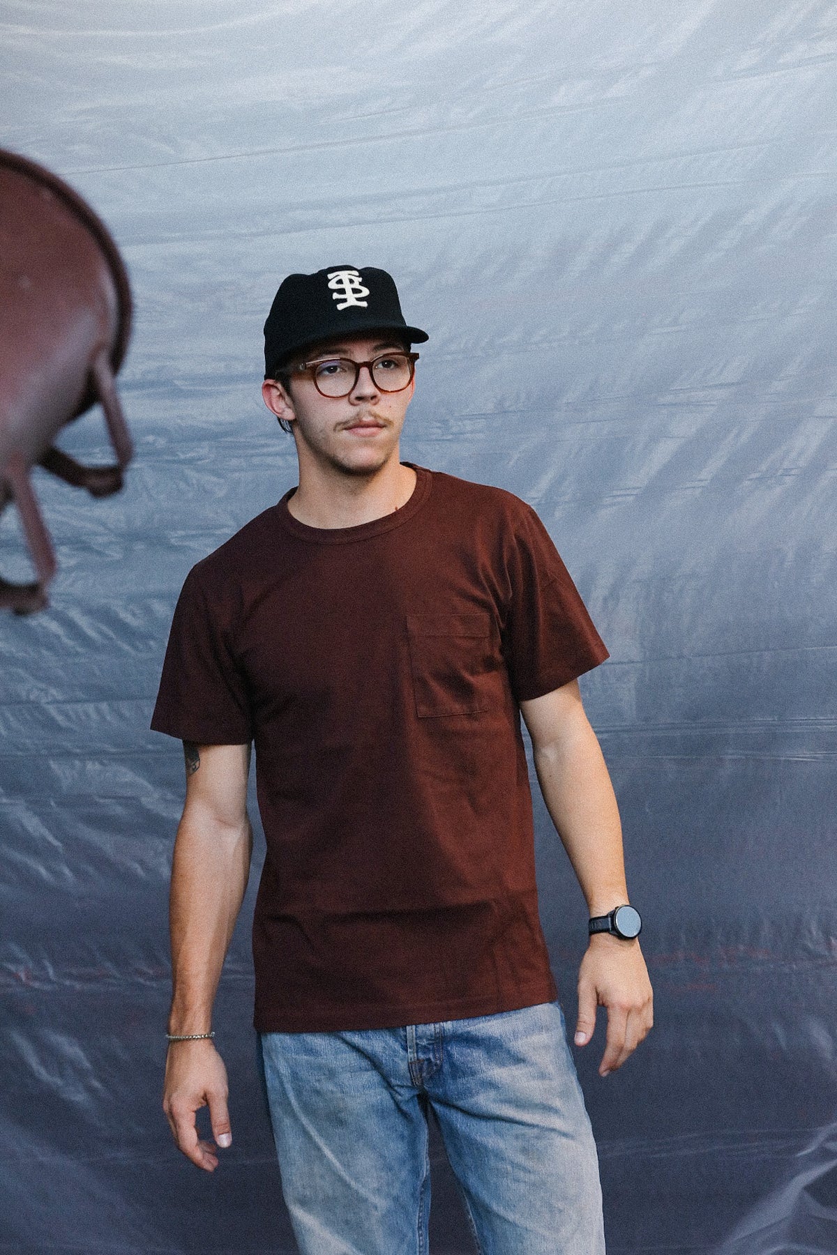 man wearing a burgundy t-shirt with a pocket