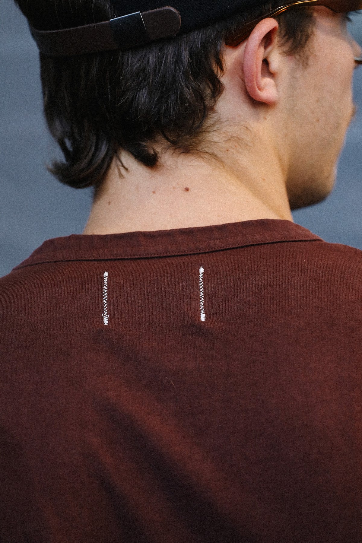 man wearing a burgundy t-shirt with a pocket