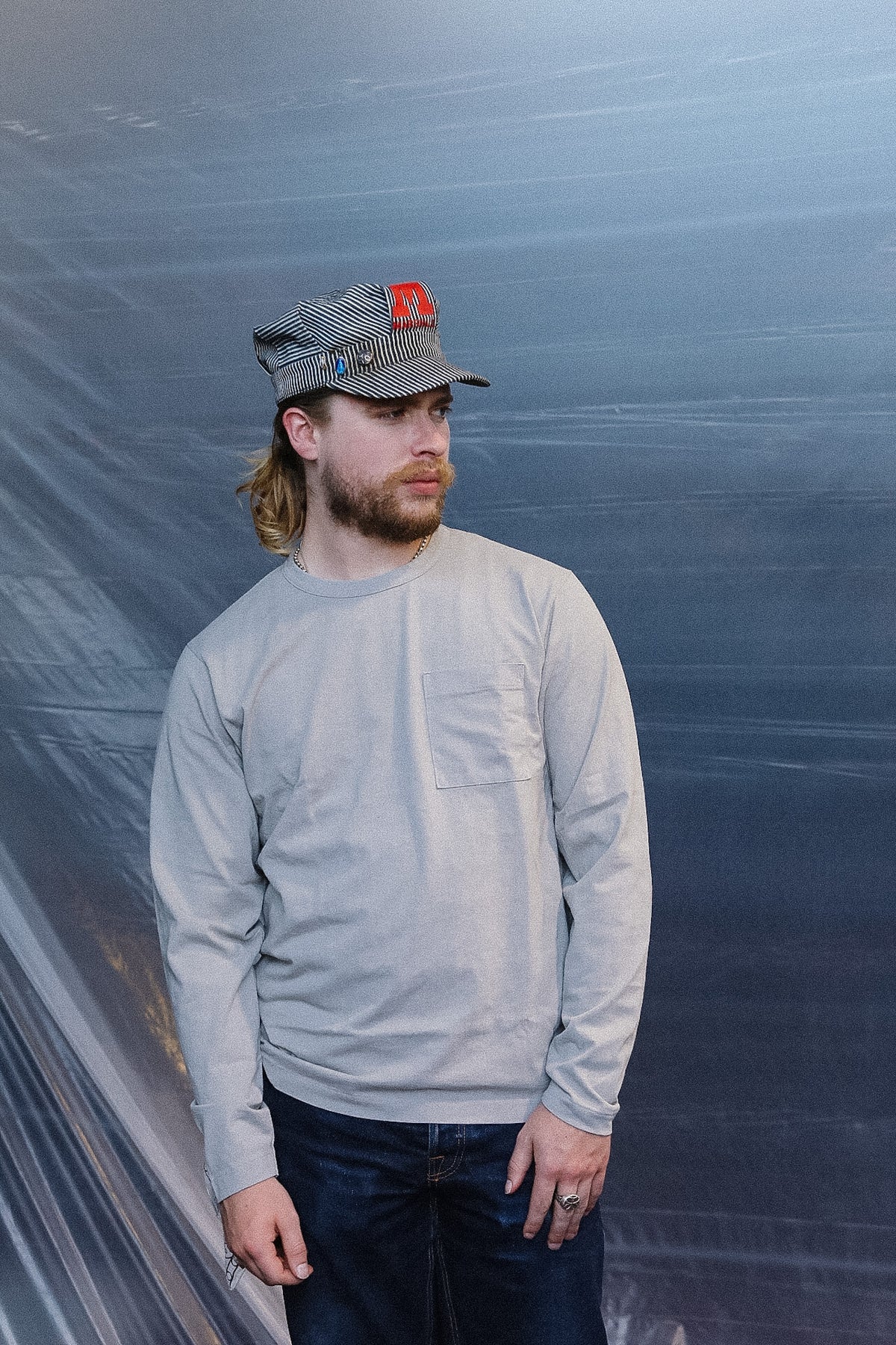 man wearing a long sleeve grey t-shirt