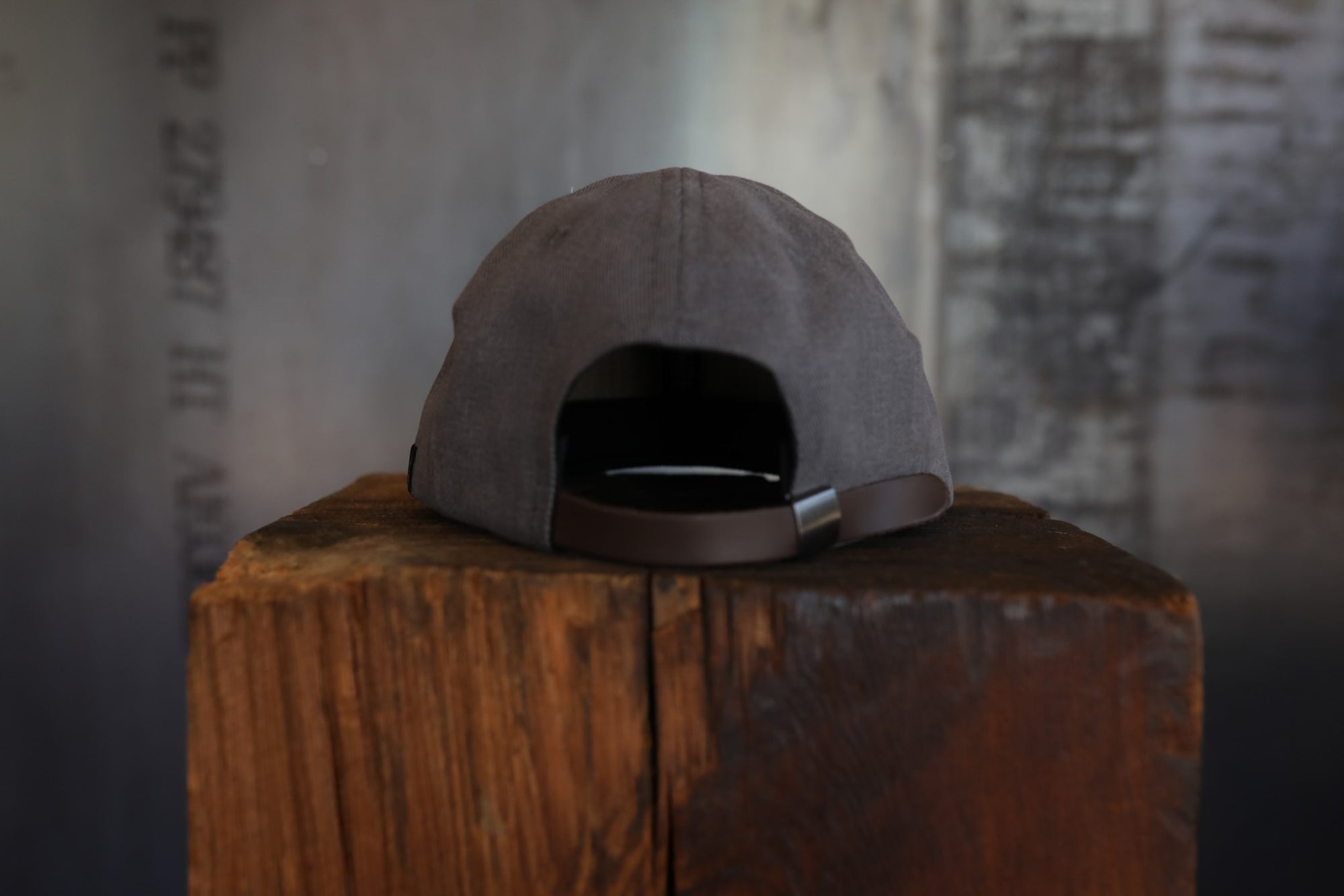 Gray cap on a wooden block with a blurred background