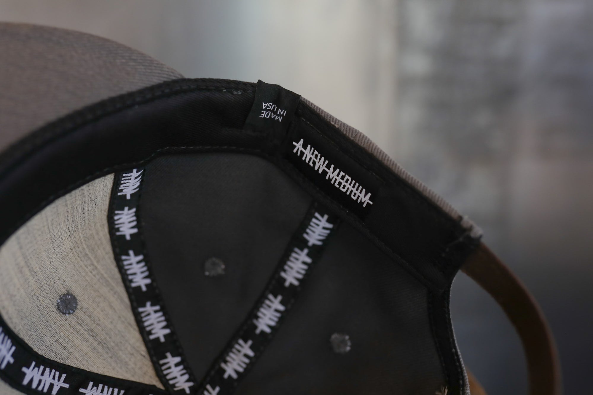 Close-up of a cap with a brand logo on a blurred background