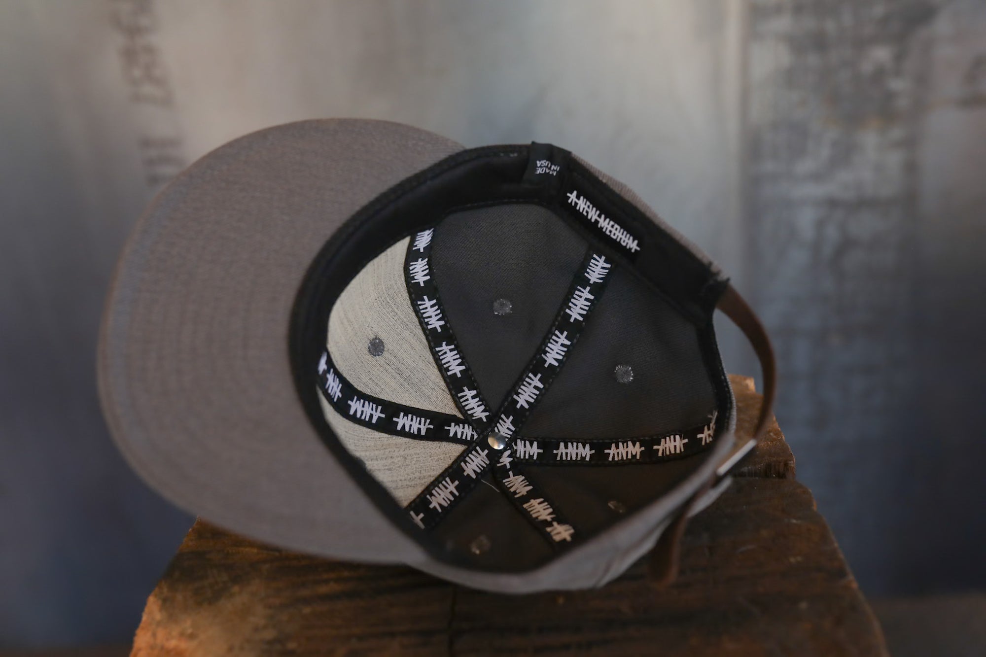 Baseball cap with a black and white pattern on a wooden surface