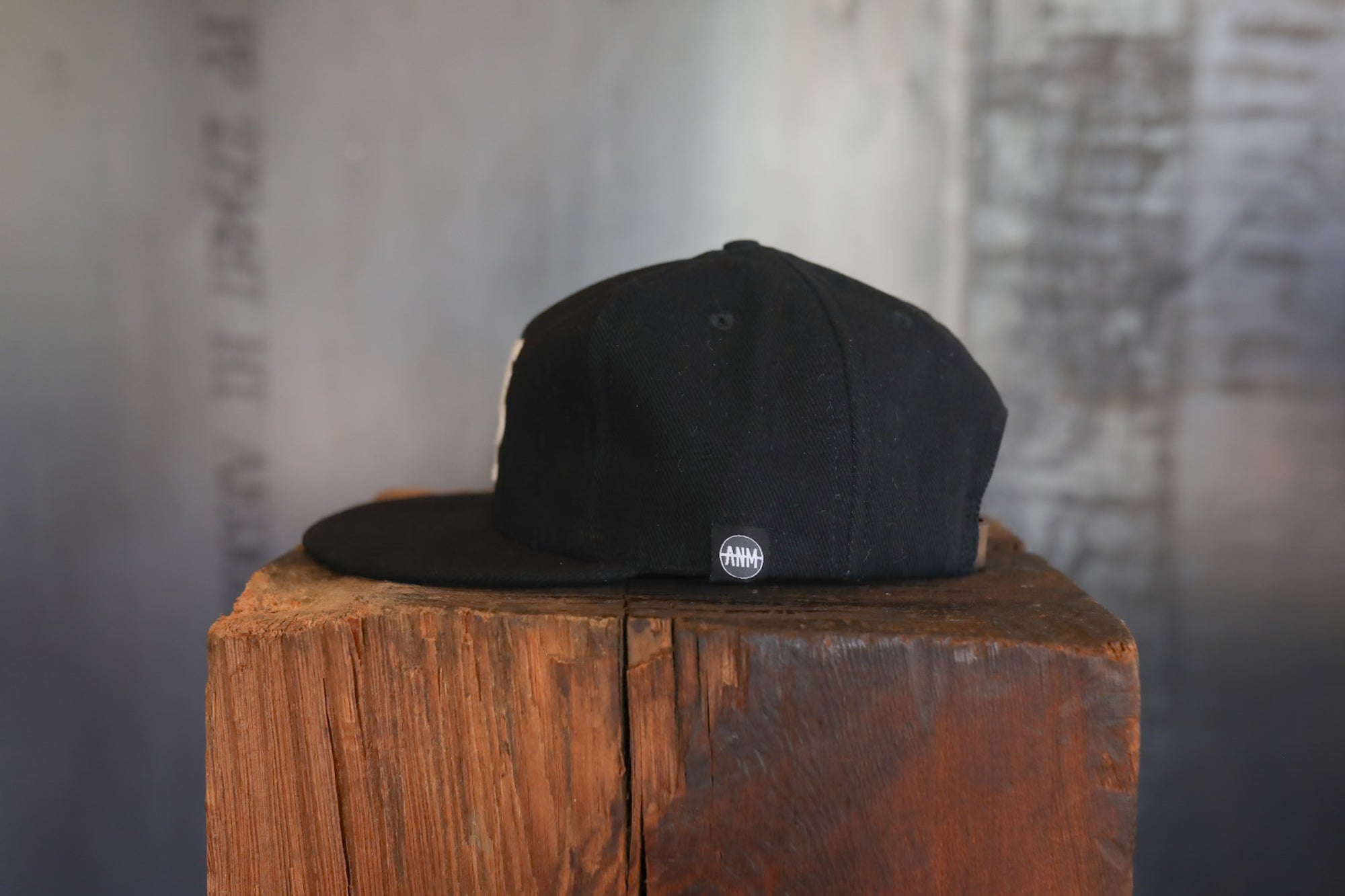 Black cap on a wooden block with a blurred background