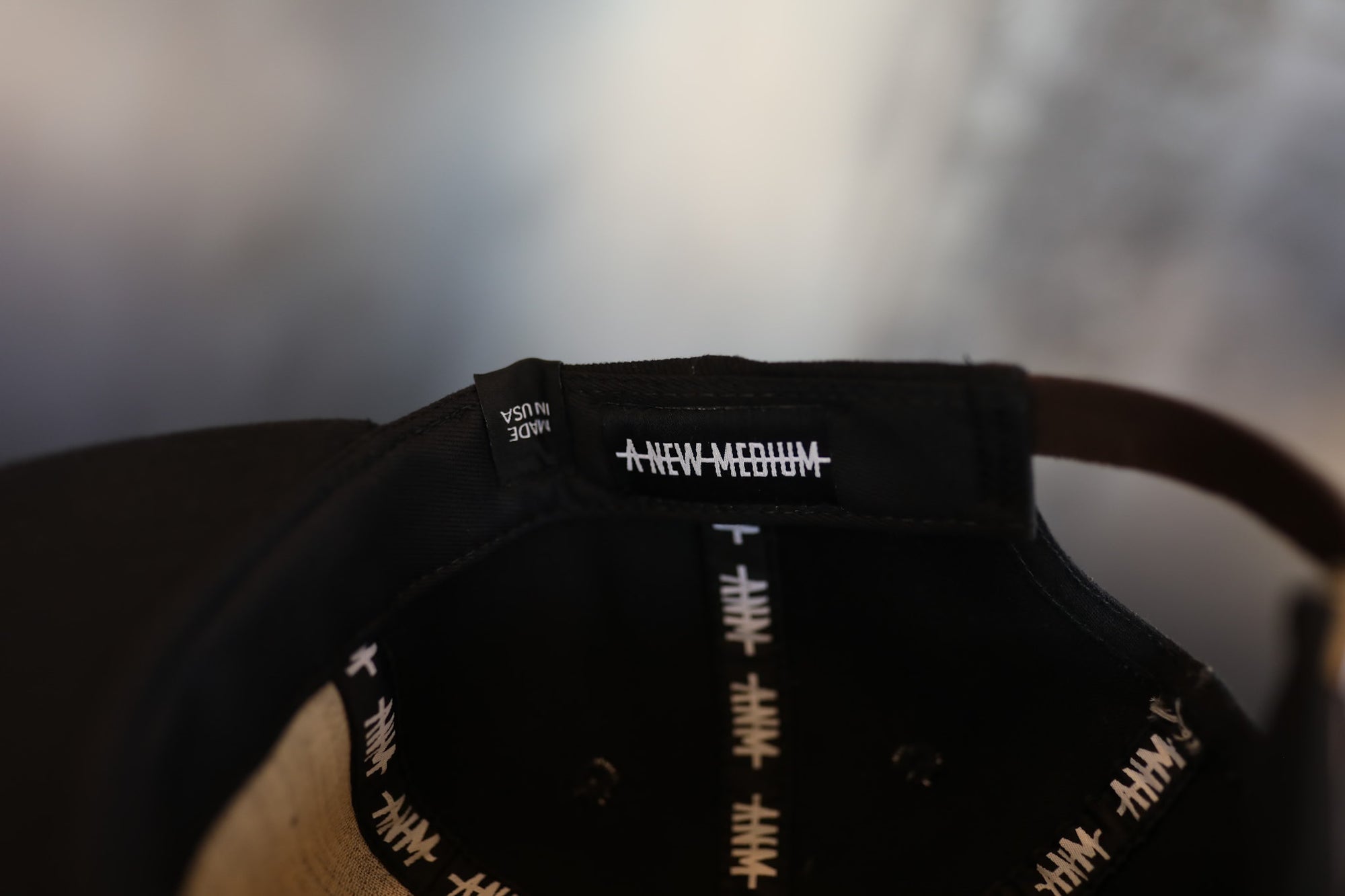 Black cap with white text on a blurred background