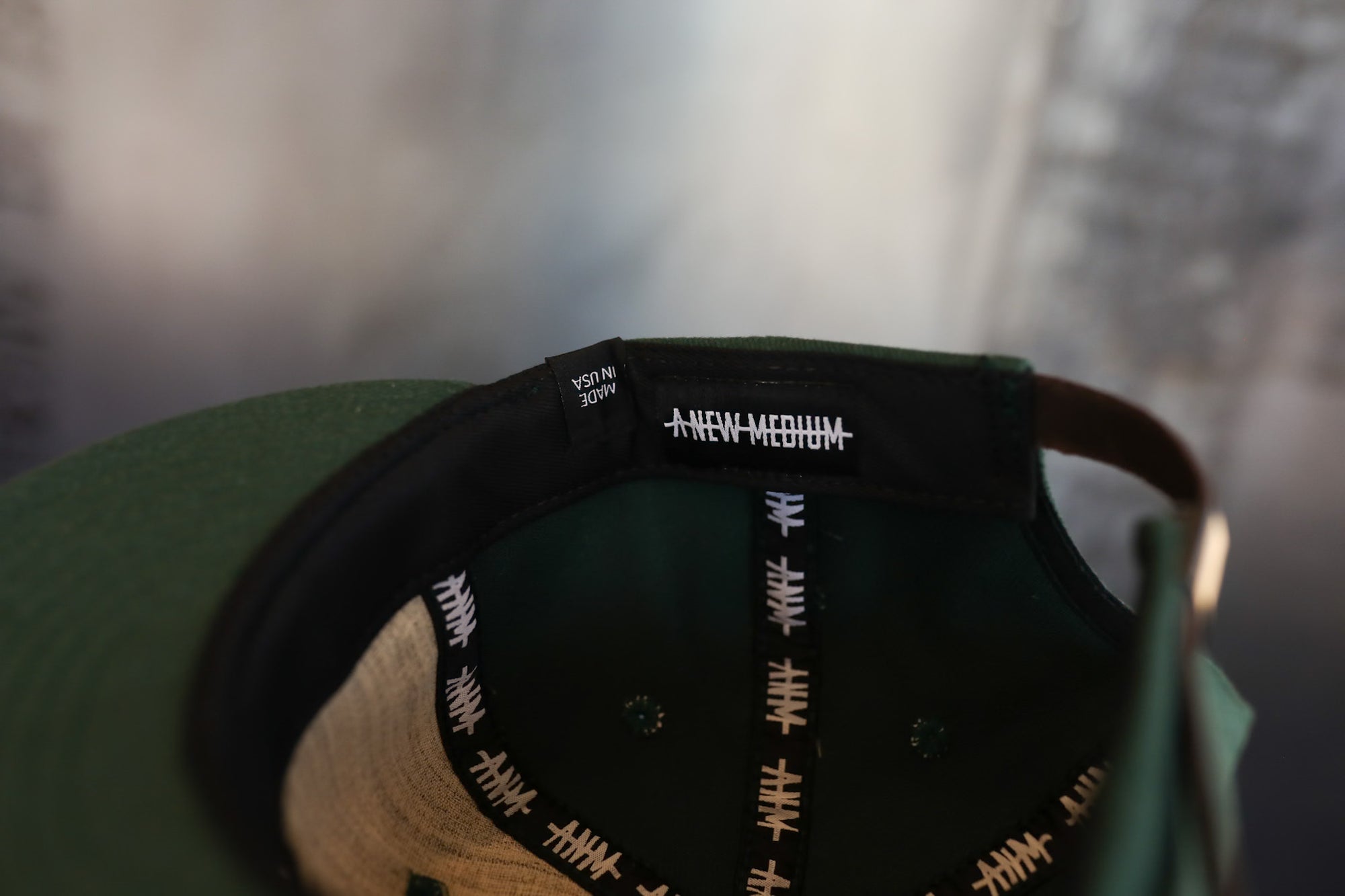 Close-up of a cap with a brand logo on a blurred background