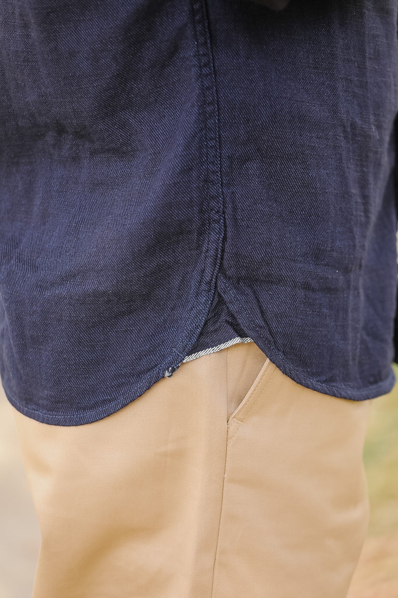 man wearing dark blue shirt on sidewalk