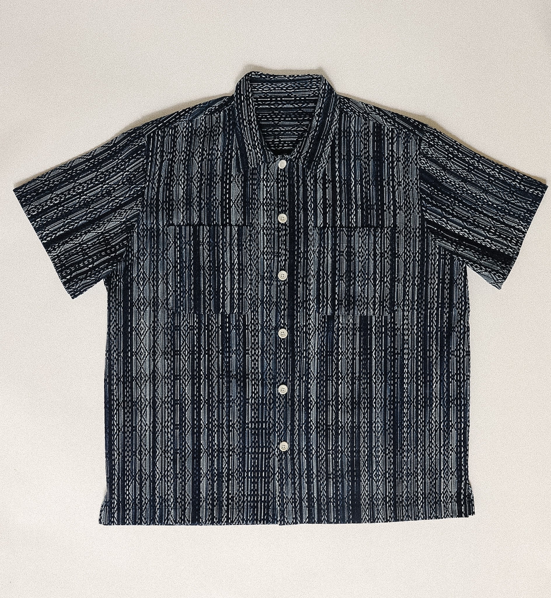 Black and white striped shirt on a light beige background