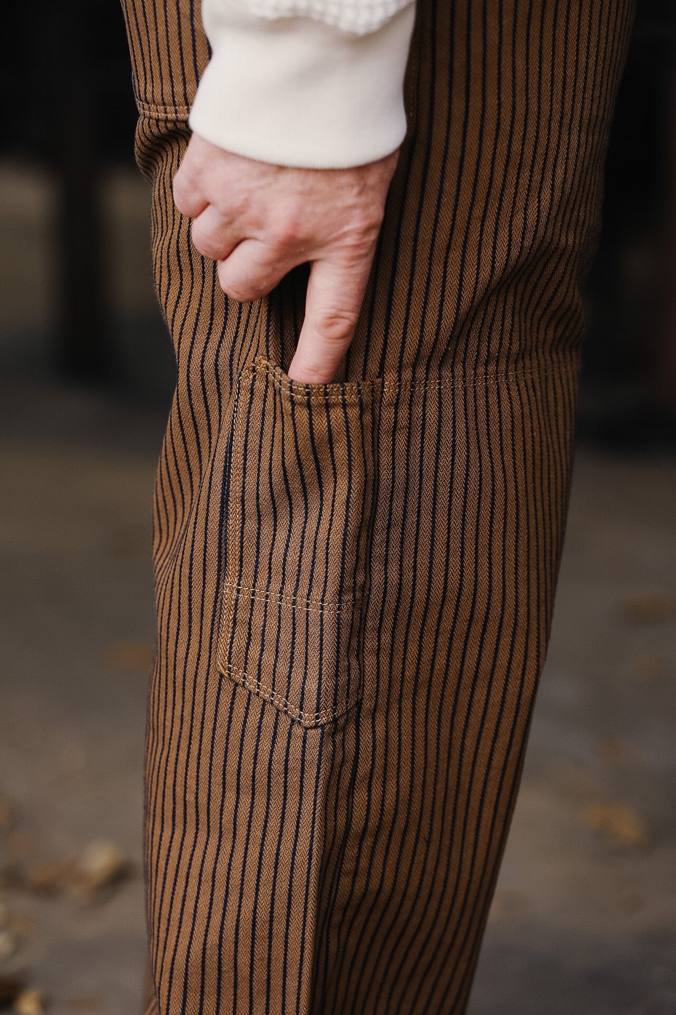 Close-up of brown striped pants with a blurred background