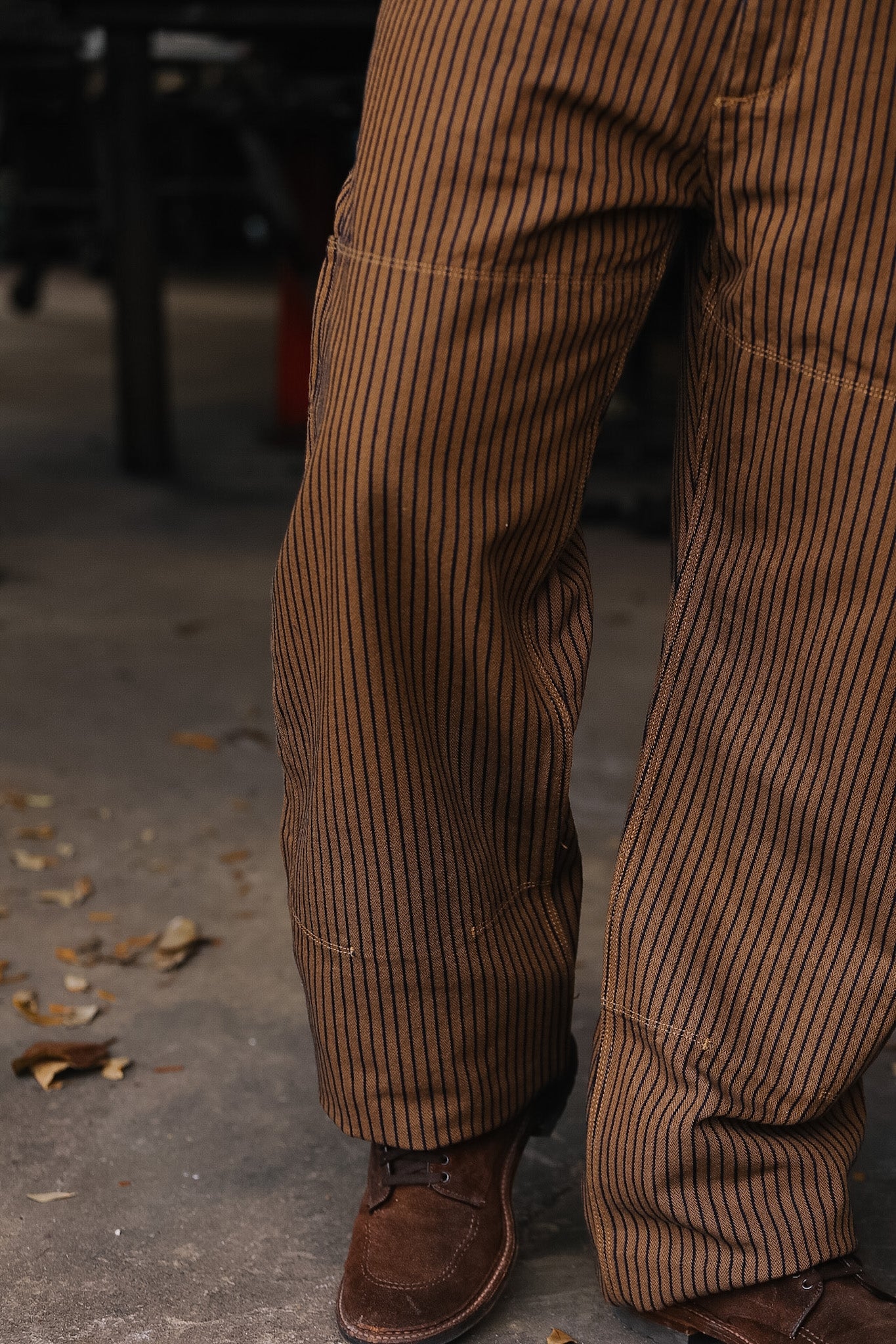 Brown pinstripe pants and shoes on a blurred background