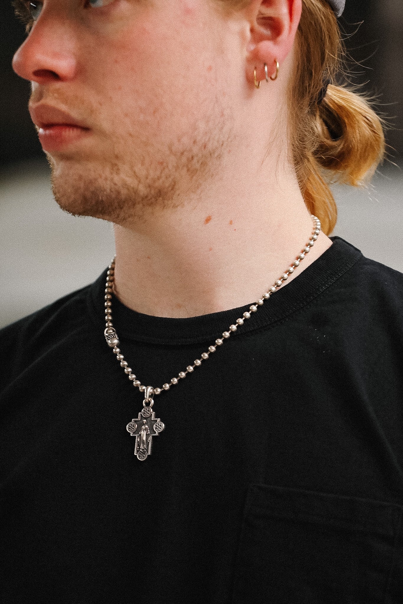 Man wearing black t-shirt on blurred background 