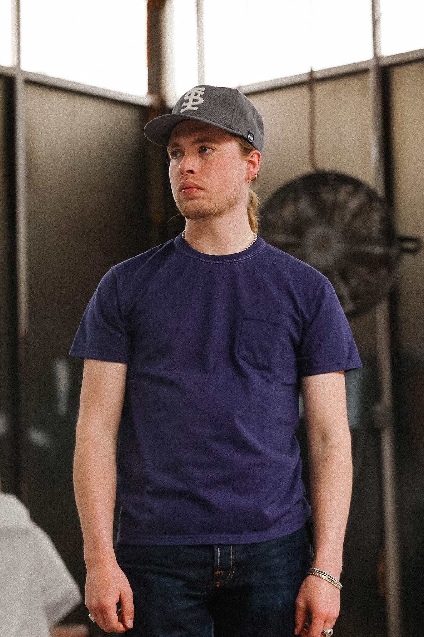 man wearing purple t-shirt on blurred background 