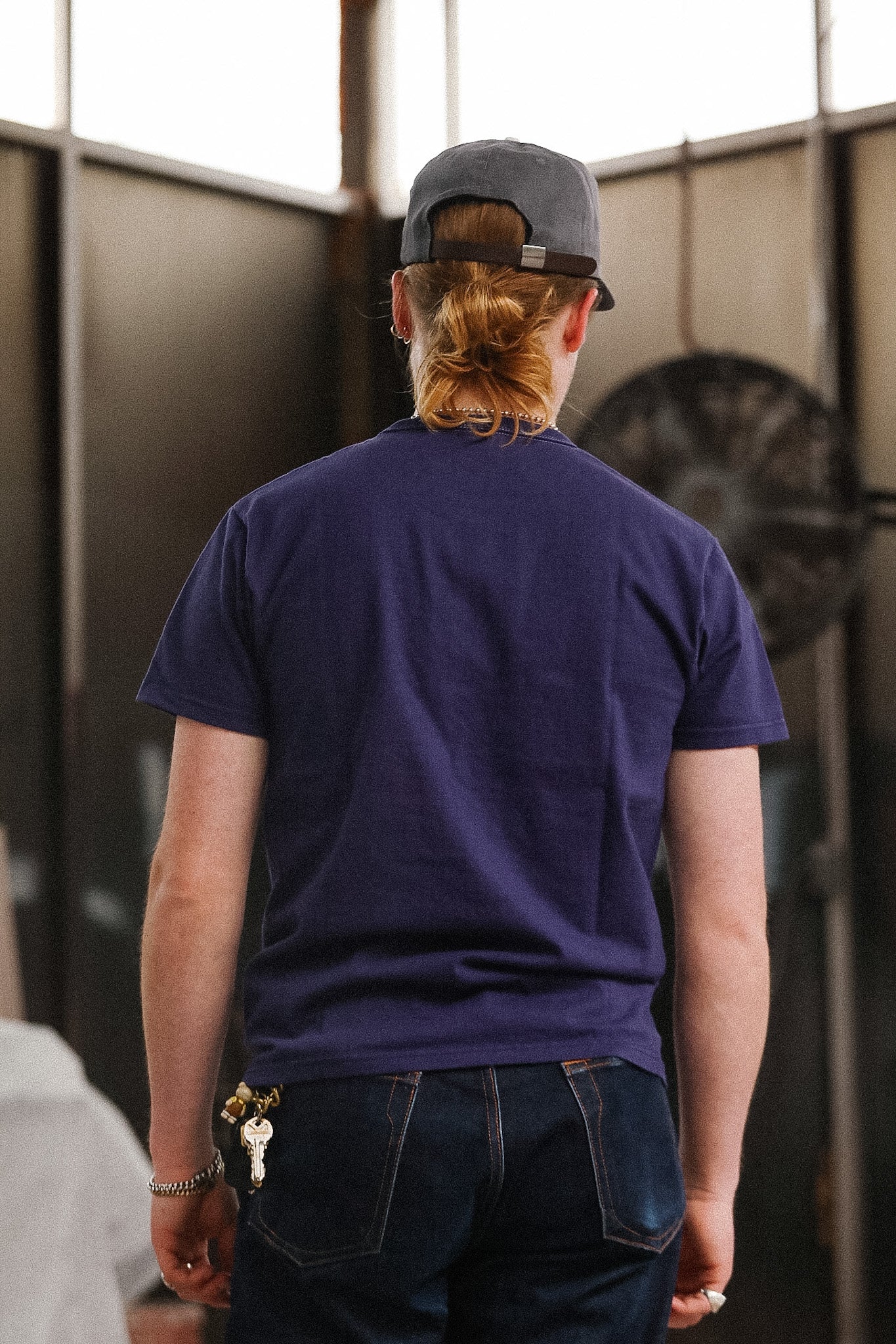 man wearing purple t-shirt on blurred background 