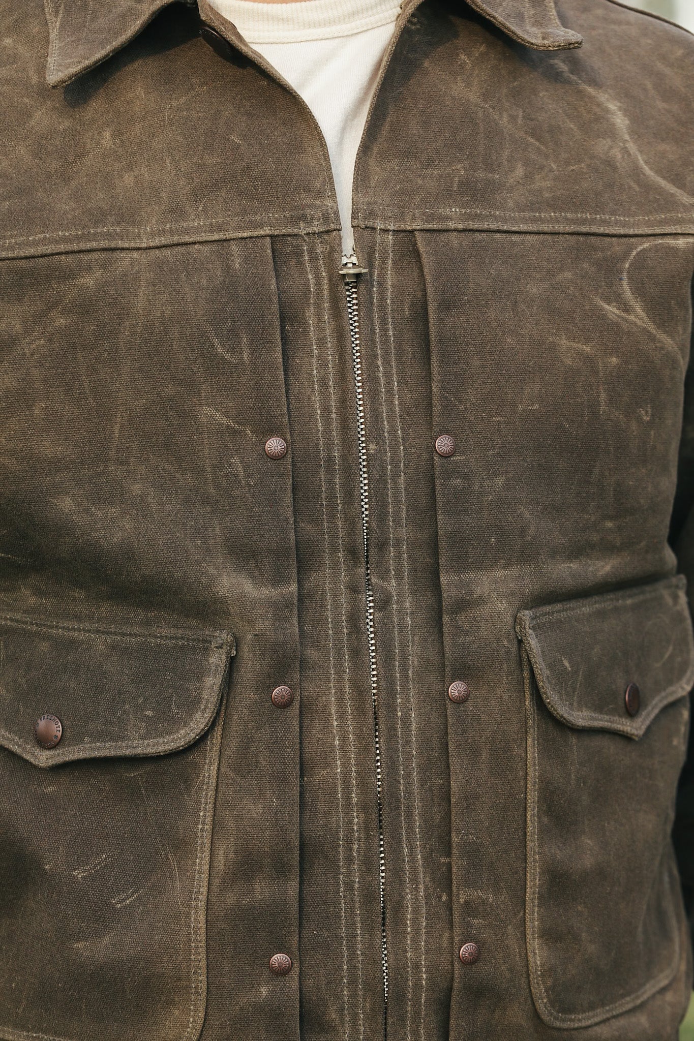 Brown leather jacket with buttons and a zipper