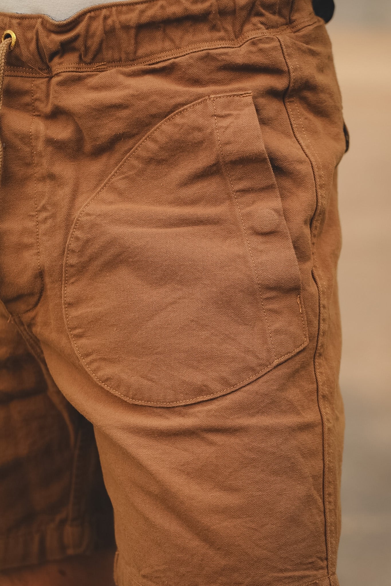 Close-up of brown pants with a blurred background