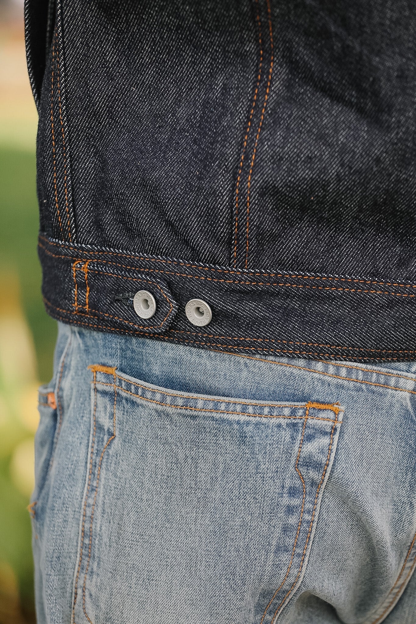 Close-up of a person wearing blue jeans with a blurred background