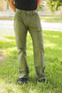 Person wearing green pants standing on grass