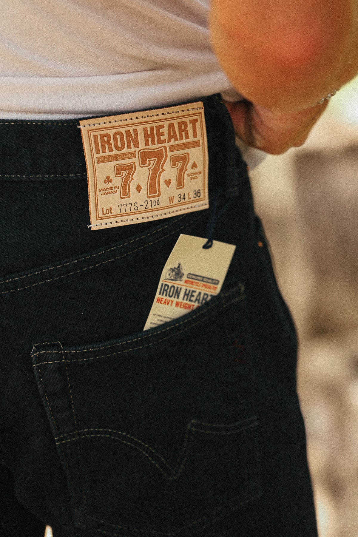 Close-up of dark blue denim jeans with an Iron Heart 7.7.