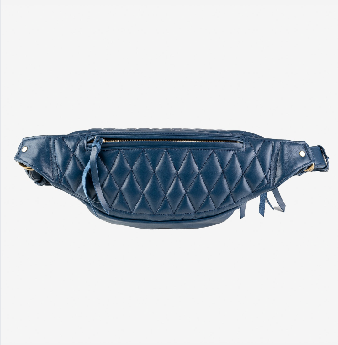 Blue quilted waist bag on a white background
