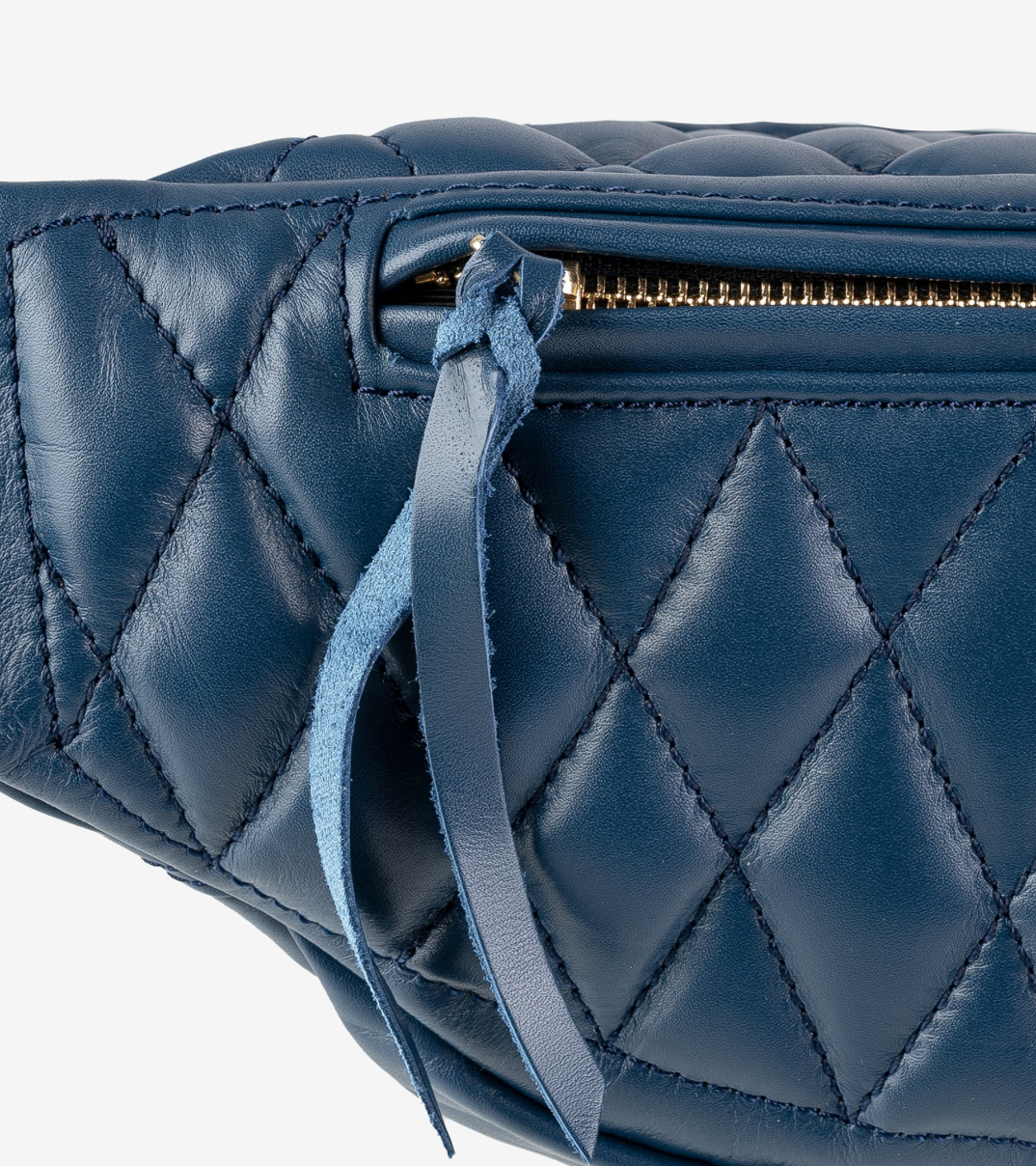 Blue quilted handbag with a strap on a white background